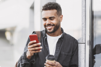 Man smiling while looking at phone