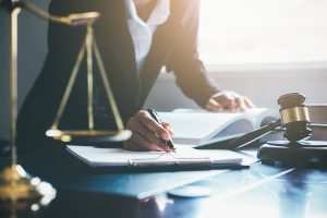 Business woman writing on clipboard in judicial office