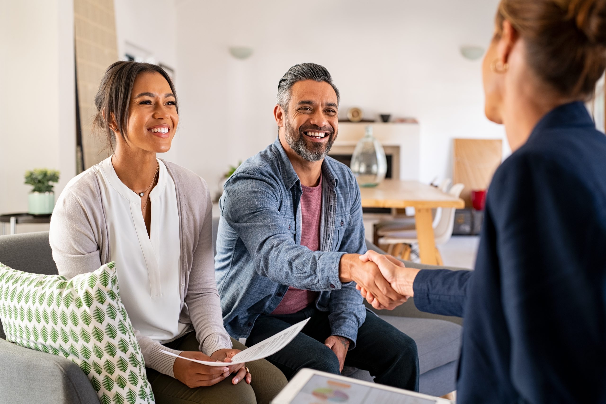 Couple shaking hands with their consultant