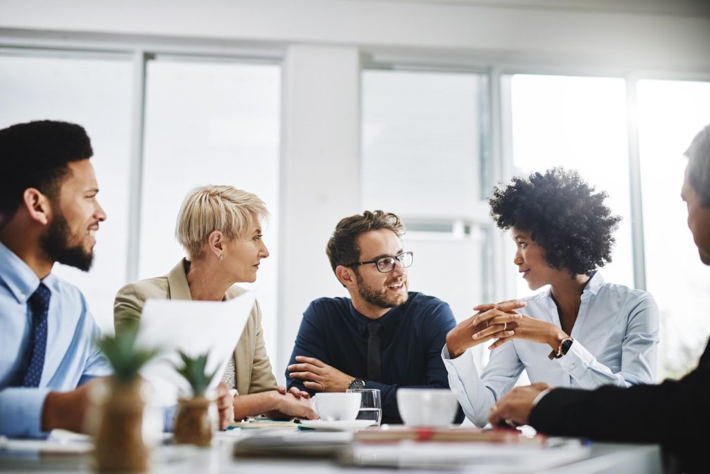 Group of coworkers making conversation in meeting