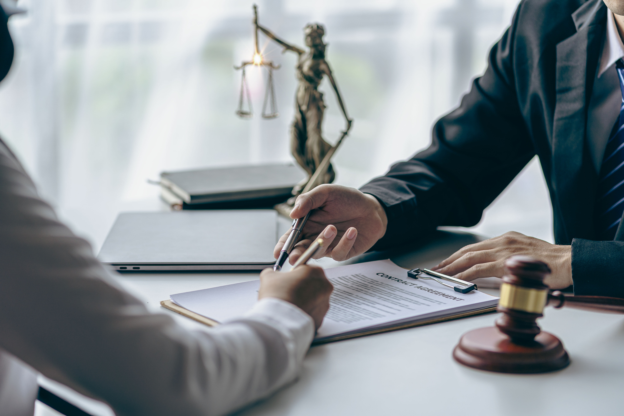 Judge and man reviewing a contract agreement together